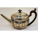 A George III silver teapot, of oval fluted form, decorated with an engraved band,