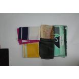 A collection of designer silk scarves comprising a Salvatore Ferragamo example;