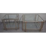 A graduated pair of 20th century polished chrome and bevelled glass two tier occasional tables,