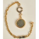 A gold key chain of oval link design, with a pendant mounted coin as fitted,