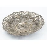 A German shaped oval basket, decorated with cherubs and floral scrolls within a beaded shaped rim,