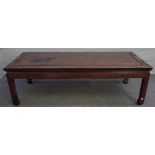 A graduated pair of early 20th century Chinese hardwood rectangular coffee tables on block supports,