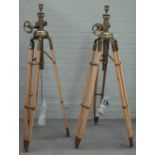 A pair of modern beech and brass height adjustable tripod standard lamps, 193cm high fully extended.