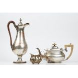 A silver cream jug raised on four bun feet, Sheffield 1905, weight 85gms,