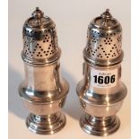 Two similar silver sugar casters of baluster form, each raised on a circular foot,