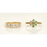 An 18ct gold and diamond set three stone ring, mounted with a row of circular cut diamonds,