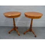 A pair of North European walnut circular occasional tables, on tripod bases,