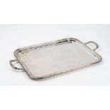 A plated rectangular twin handled tray, decorated with reeded rims, with crossover motifs,