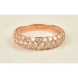A gold and diamond set half hoop eternity ring, mounted with three rows of circular cut diamonds,