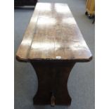 A 17th century and later fruitwood tavern table on slab end supports united by a stretcher,