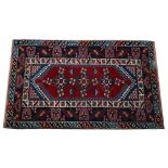 A Yagcibedir Turkish rug, the madder field with three flowerheads,