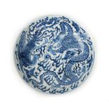 A Chinese Kangxi style blue and white dish, painted with a dragon and phoenix amongst cloud scrolls,