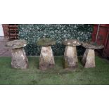 A set of four staddle stones with tapering square bodies and mushroom tops, each approx 70cm high,