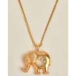 A gold and diamond pendant designed as a standing elephant,
