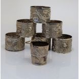 A set of six Chinese napkin rings decorated with dragons and a Chinese miniature bucket with