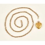 A gold oval and multiple link neckchain, on a cylindrical clasp and a gold heart shaped pendant,