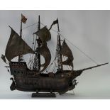 A 19th century scratch built painted wooden model of a galleon, approximate length 106cm.