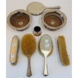 A silver mounted five piece dressing set, comprising; a hand mirror,