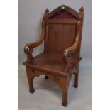 An early 20th century pitch pine Gothic revival open armchair, 62cm wide x 155cm high.