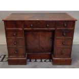A George III mahogany kneehole writing desk with nine drawers about the knee on a plinth base,