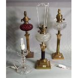 A group of three early 20th century brass oil lamps, later converted to electricity,