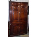 A late 18th century oak floor standing corner cupboard with panelled doors, 111cm wide x 198cm high.