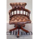 A modern stained beech office open armchair with brown leather buttonback upholstery,