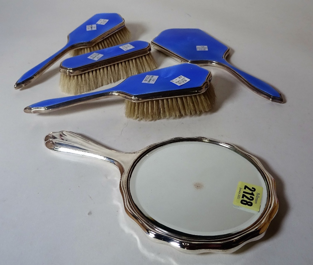 A modern silver mounted and blue enamel dressing table set and a silver plated hand mirror, (5).