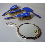 A modern silver mounted and blue enamel dressing table set and a silver plated hand mirror, (5).