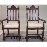 A pair of 18th century style oak high back open armchairs, 53cm wide x 116cm high.