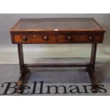 An early Victorian mahogany two drawer writing table on bun feet, 92cm wide x 76cm high.