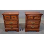 A pair of 20th century pine bedside chests, each with an arrangement of four drawers,