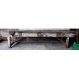 A 19th century hardwood work bench, 340cm wide x 85cm high.