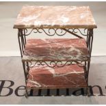 A gilded wrought metal rectangular three tier etagere, inset with rouge royal marble panels,