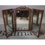 An 18th century style gilt gesso framed triptych mirror, 107cm wide x 70cm high.