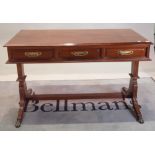 A Regency style stained beech writing desk, with three frieze drawers, on downswept supports,