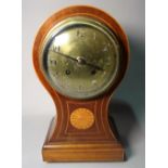 An Edwardian inlaid mahogany balloon shaped mantel clock with silver enamel dial,