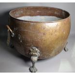 A Victorian twin handled copper bowl on claw supports, 55cm wide x 41cm high.