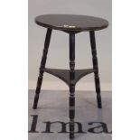 A late 19th century ebonised circular two tier occasional table, on turned supports,