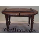 A 19th century mahogany oval extending dining table, with one extra leaf on turned supports,