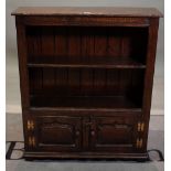 An 18th century style oak two tier open bookcase with cupboard base, 84cm wide x 98cm high.