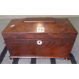 A Regency mahogany tea caddy of sarcophagus form on bun feet, 31cm wide x 19cm high.