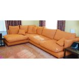 A contemporary Long Island sectional sofa, in three parts, upholstered in orange woven fabric,