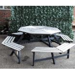 A modern metal framed and hardwood octagonal garden table with four integral benches,