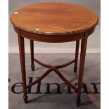 An Edwardian mahogany and satinwood banded circular centre table on tapering square supports,