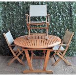 A modern hardwood circular extending garden table,