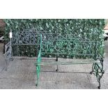 A pair of cast iron garden benches with fruiting vine decoration, 120cm wide x 83cm high, (a.f.