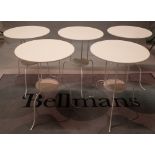 A set of five modern white painted metal circular two tier occasiona/cafel tables,