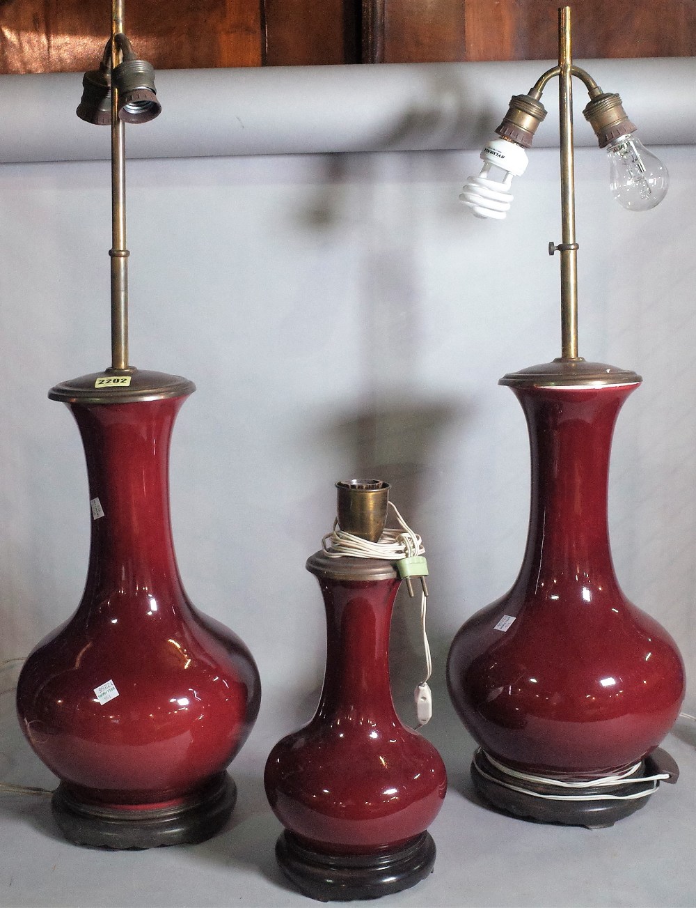 A pair of modern Chinese Sang De Beouf vases, later converted to lamps, 80cm high,