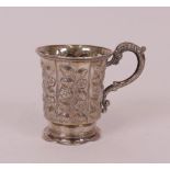 A Victorian silver christening mug, the body panels decorated with floral sprays, with a...